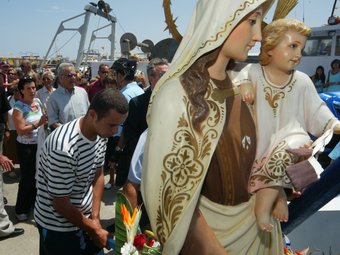 La verge és carregada en una embarcació per encapçalar la processó marítima que surt del port de Llançà.  LLUÍS SERRAT