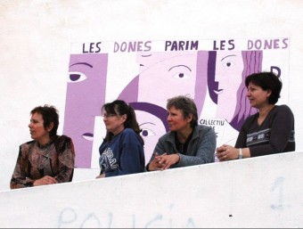 Representants dels col·lectius de dones davant un mural. ARXIU