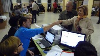 Una votant saluda als membres de la mesa després de votar, al col·legi Joan XXIII de Lleida. D.M