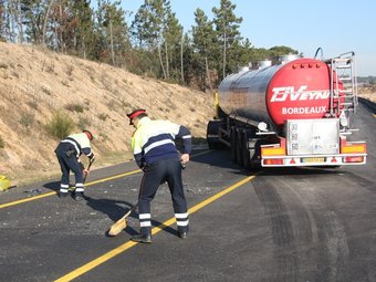 El lloc on va produir-se l'accident de l'N-II a Sils, on un Mosso neteja la via, el camió cisterna implicat en l'accident. XAVIER PI / ACN