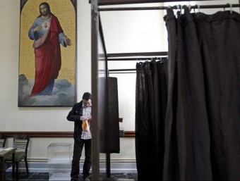 Una persona prepara els seus vots abans d'accedir a la urna. EL PUNT AVUI