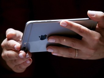 The new iPhone 6 Plus can be used horizontally as well as vertically, like the iPad and most Android phones.  AFP