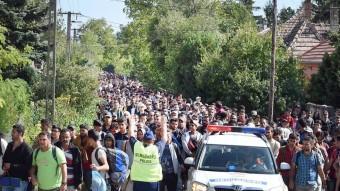 Un policia hongarès intenta dirigir una columna de desplaçats en ruta cap a Àustria, aquest dissabte a Hegyeshalom EFE