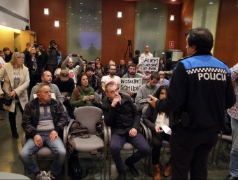 El cap de la Policia Local, Joaquim Martín, demanant calma als assistents que no havien marxat de la sala quan ho va dictaminar l'alcalde. QUIM PUIG