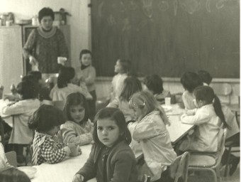 A dalt, la imatge de l'interior d'un aula de l'escola amb nens quan es va posar en marxa a finals del setanta.  CEDIDA/S. PÉREZ